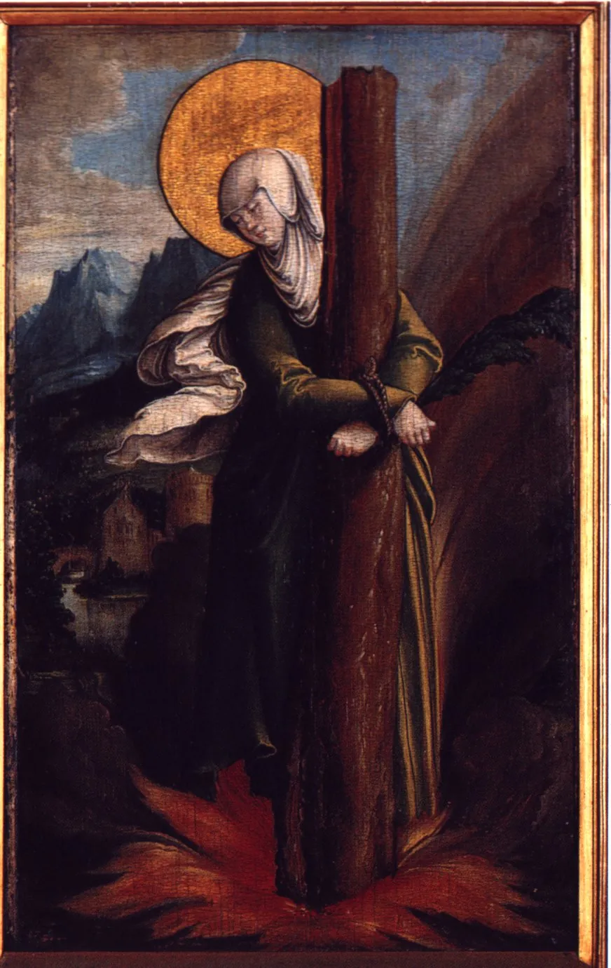 Sixteenth-century German panel painting of a woman in a white veil and dark green dress with a gold halo, her wrists tied with rope around a tall tree trunk, flames rising at her feet and a palm branch behind her, with mountains and a castle in the distance