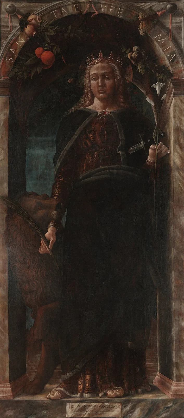 Fifteenth-century Italian panel painting of a young woman crowned and haloed, in a dark cloak over a red gown, standing in a stone archway hung with fruit garlands; she holds a lily and a sword in one hand, a lion bites the other hand, and the arch is inscribed SANCTA EVFEMIA