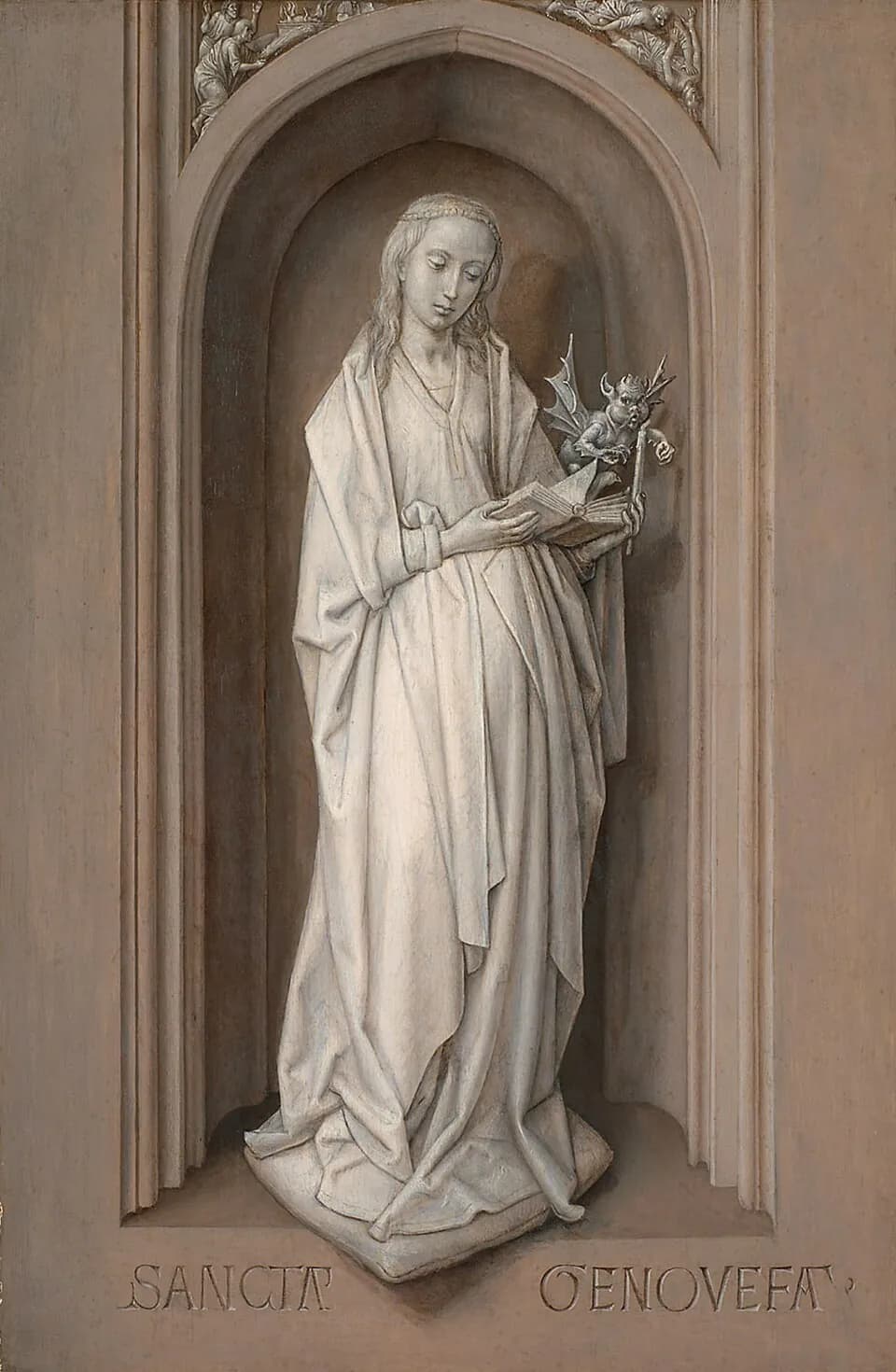 A painted stone-colored figure of a young woman with long hair stands in a Gothic niche reading a book, holding a candle on which a small winged devil perches, above the carved words Sancta Genovefa