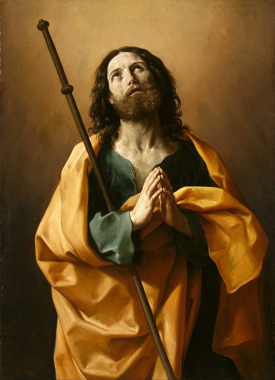 Saint James the Greater in a yellow cloak, holding a pilgrim's staff with his hands joined and his eyes raised, painted by Guido Reni