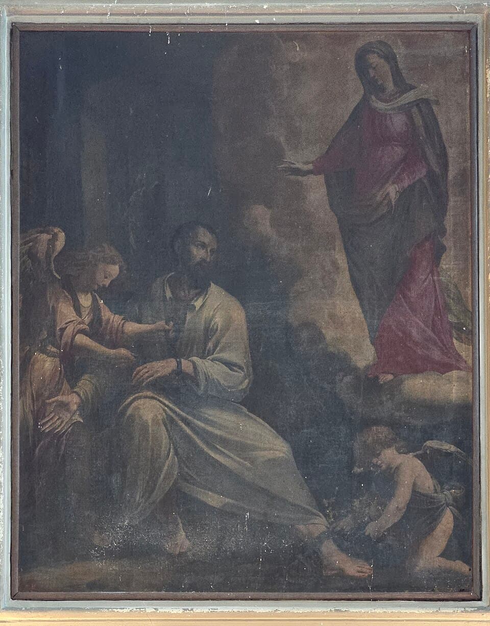 A darkened altar painting of the liberation of Saint Jerome Emiliani, the bearded prisoner seated in a cell while an angel unfastens his chains and the Virgin stands above in a crimson robe