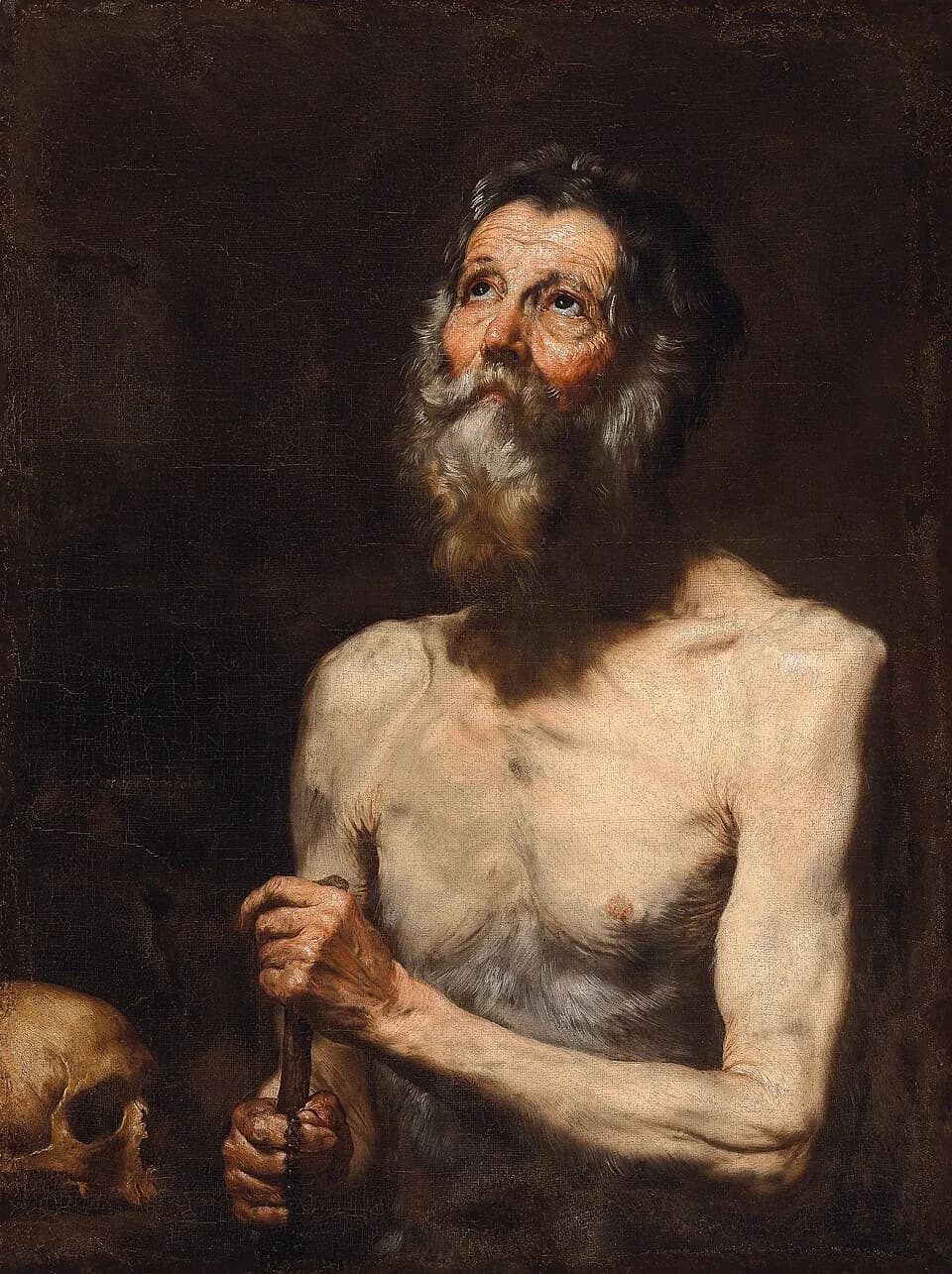 Seventeenth-century painting of an old, bare-chested man with a weathered face and a long gray beard looking upward, both hands closed around the top of a wooden staff, with a skull in the lower corner against a dark background