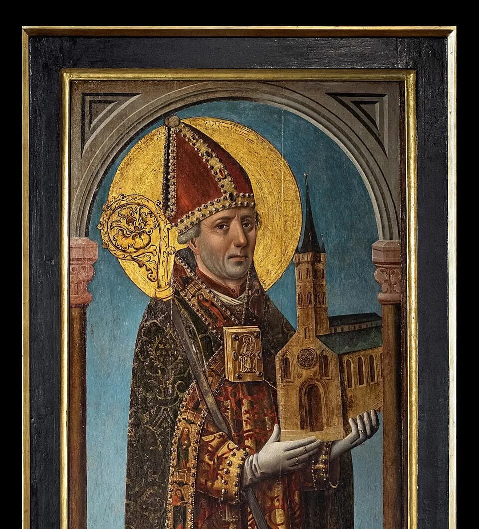 A medieval panel painting of a bishop in a red jeweled miter and gold vestments, with a golden halo and crozier, holding a model of a twin-towered church in his gloved hands