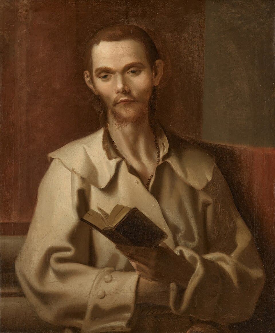 A painted portrait of Benedict Joseph Labre as a thin young man with a sparse beard, wearing a heavy pale coat with a wide collar and a dark rosary at his throat, holding an open book