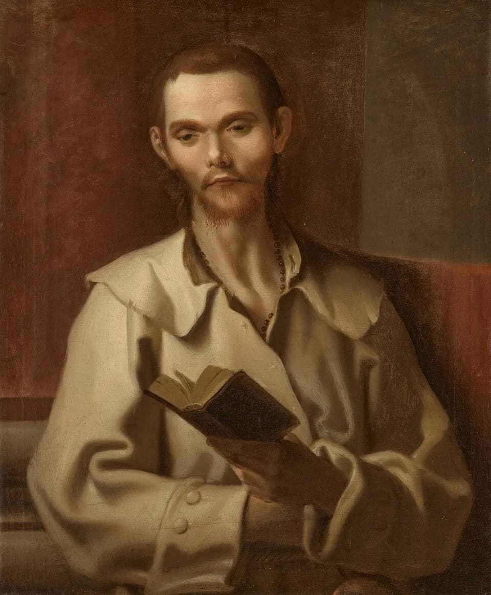 Retrato pintado de Benito José Labre, un joven delgado de barba rala, con un grueso abrigo claro de cuello ancho y un rosario oscuro al cuello, que sostiene un libro abierto