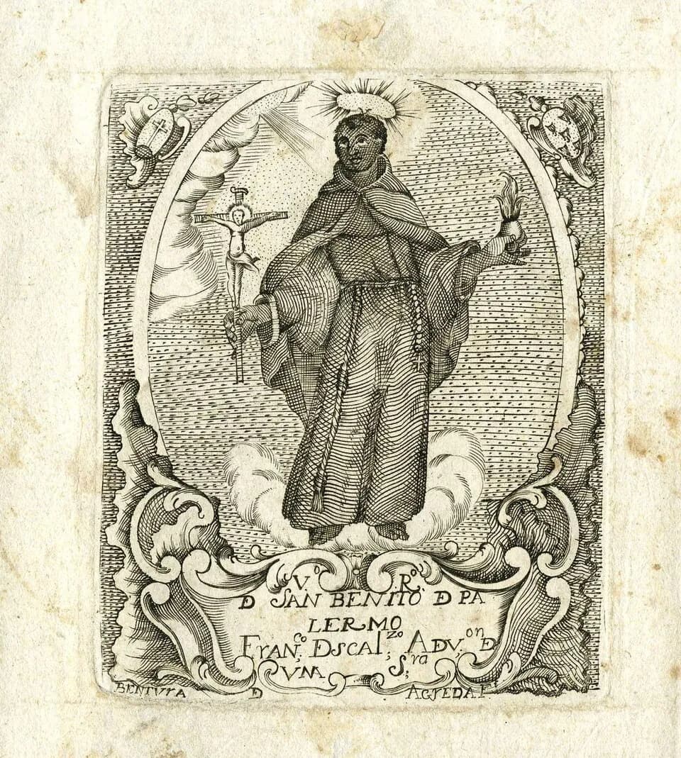 Eighteenth-century engraving of Saint Benedict of Palermo standing on clouds in a Franciscan habit and cord, with a halo, holding a crucifix in one hand and a flaming heart in the other, inside an oval frame with a lettered cartouche below
