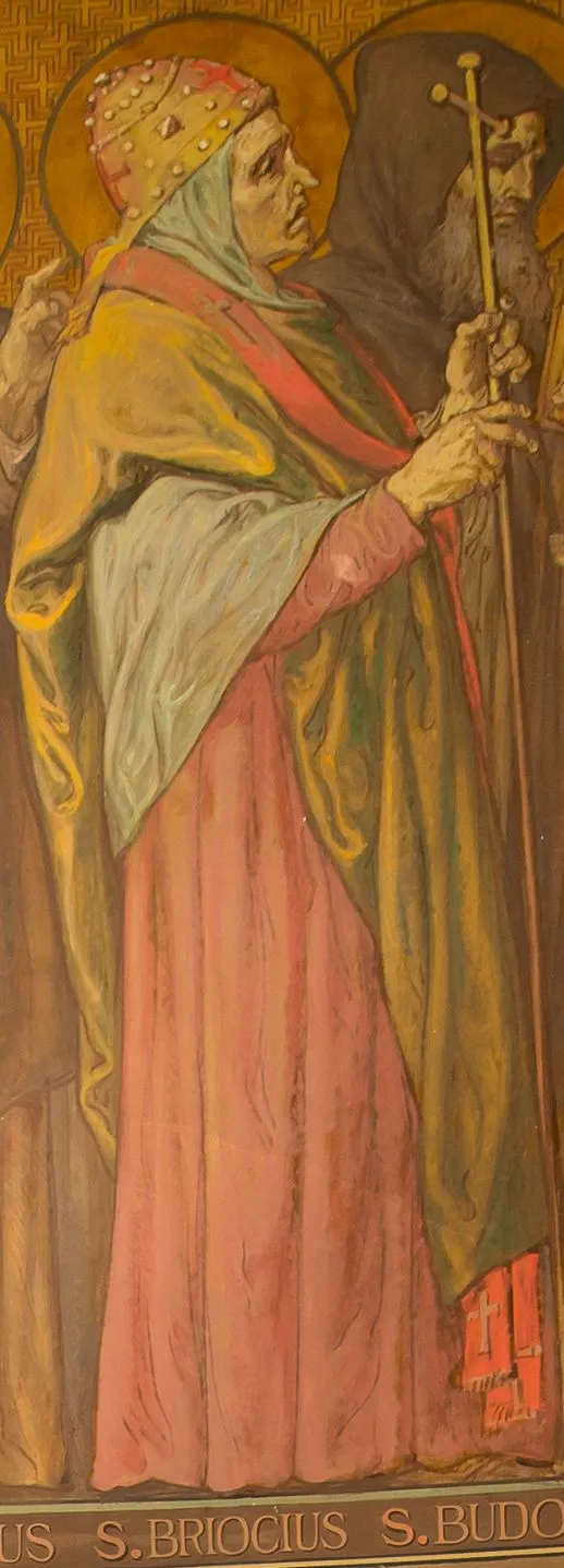 Detail of a nineteenth-century mural on a gold patterned ground: an elderly bishop with a halo, wearing a jeweled red and gold miter over a pale hood, a gold mantle and a rose-colored robe, holding a tall processional cross, beside a hooded bearded monk, above the painted caption S. BRIOCIUS