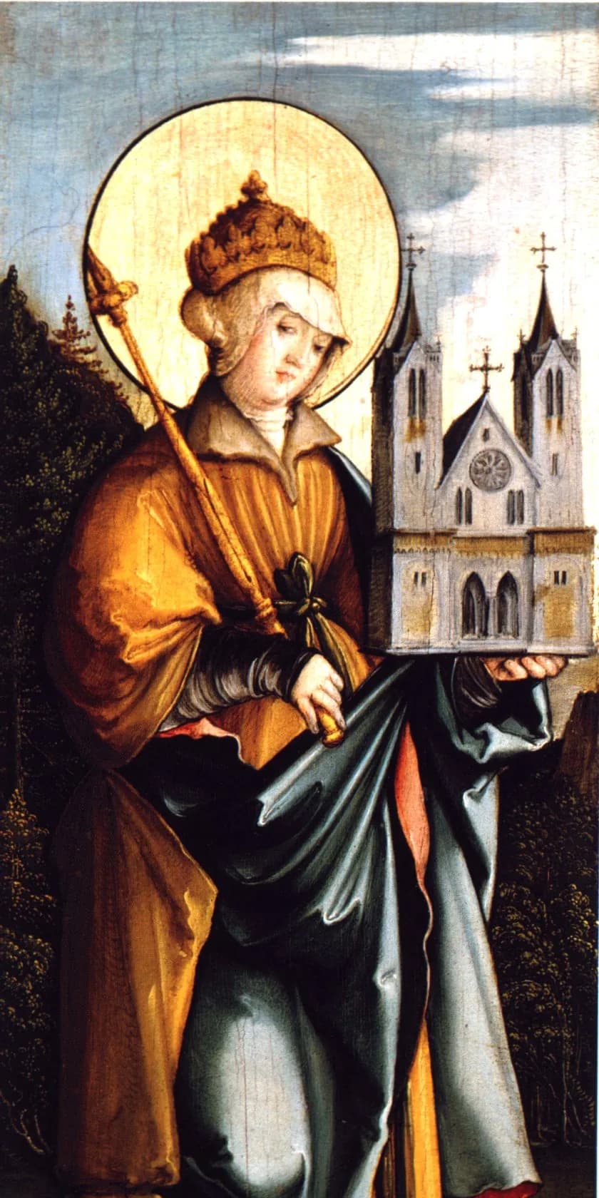 A crowned woman with a golden halo, in a yellow robe and a blue-gray mantle, holds a scepter in one hand and a model of a twin-towered church in the other, against a wooded hillside