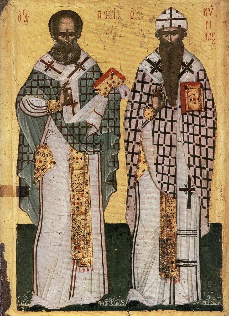Icono cretense de dos obispos de pie, uno junto al otro, sobre fondo dorado, con vestiduras de cruces, cada uno bendiciendo y sosteniendo un libro de los Evangelios con joyas: Atanasio a la izquierda y, a la derecha, Cirilo, de larga barba, con el gorro blanco marcado con cruces, y su nombre escrito en griego sobre él