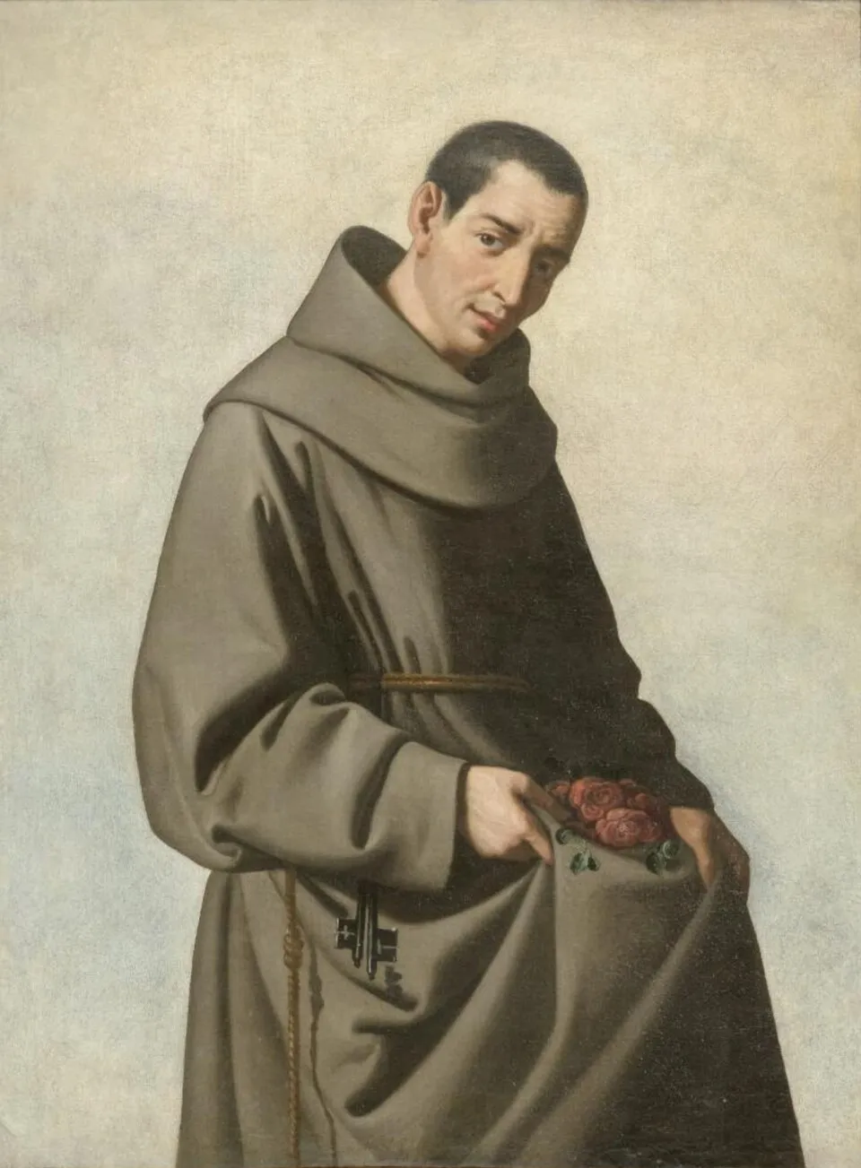 Painting of a young, dark-haired Franciscan friar in a gray-brown habit against a pale background, head tilted toward the viewer, holding up a fold of his habit filled with red roses