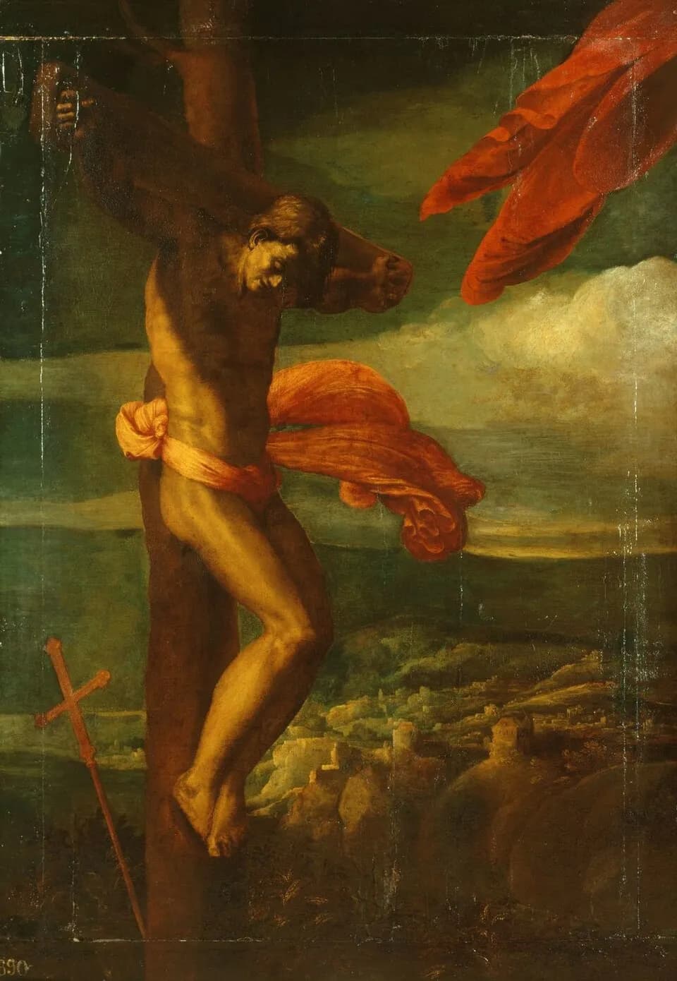 Painting of a nearly naked man bound to a rough tree-trunk cross with his arms hooked over the crossbeam, his head bowed and turned to the side, an orange cloth blowing from his waist against a green stormy sky, with a walled town in the valley below