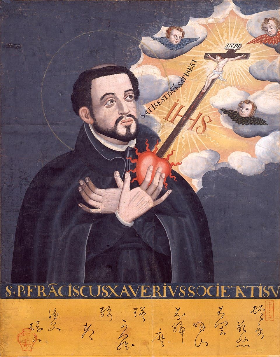 Saint Francis Xavier in a black Jesuit soutane holding a flaming heart, with a radiant cross above and Japanese calligraphy along the lower border, in a Japanese devotional painting