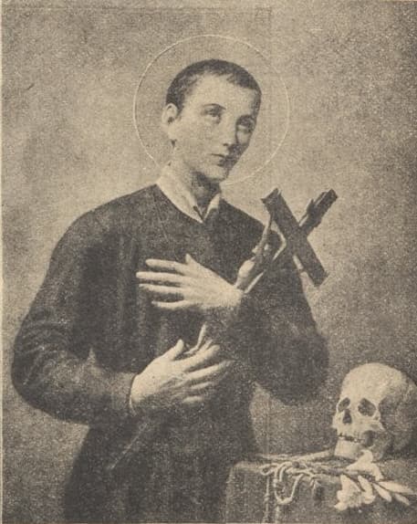 Saint Gerard Majella in a dark religious habit with a halo, one hand on his chest and the other holding a crucifix, beside a skull and a spray of flowers