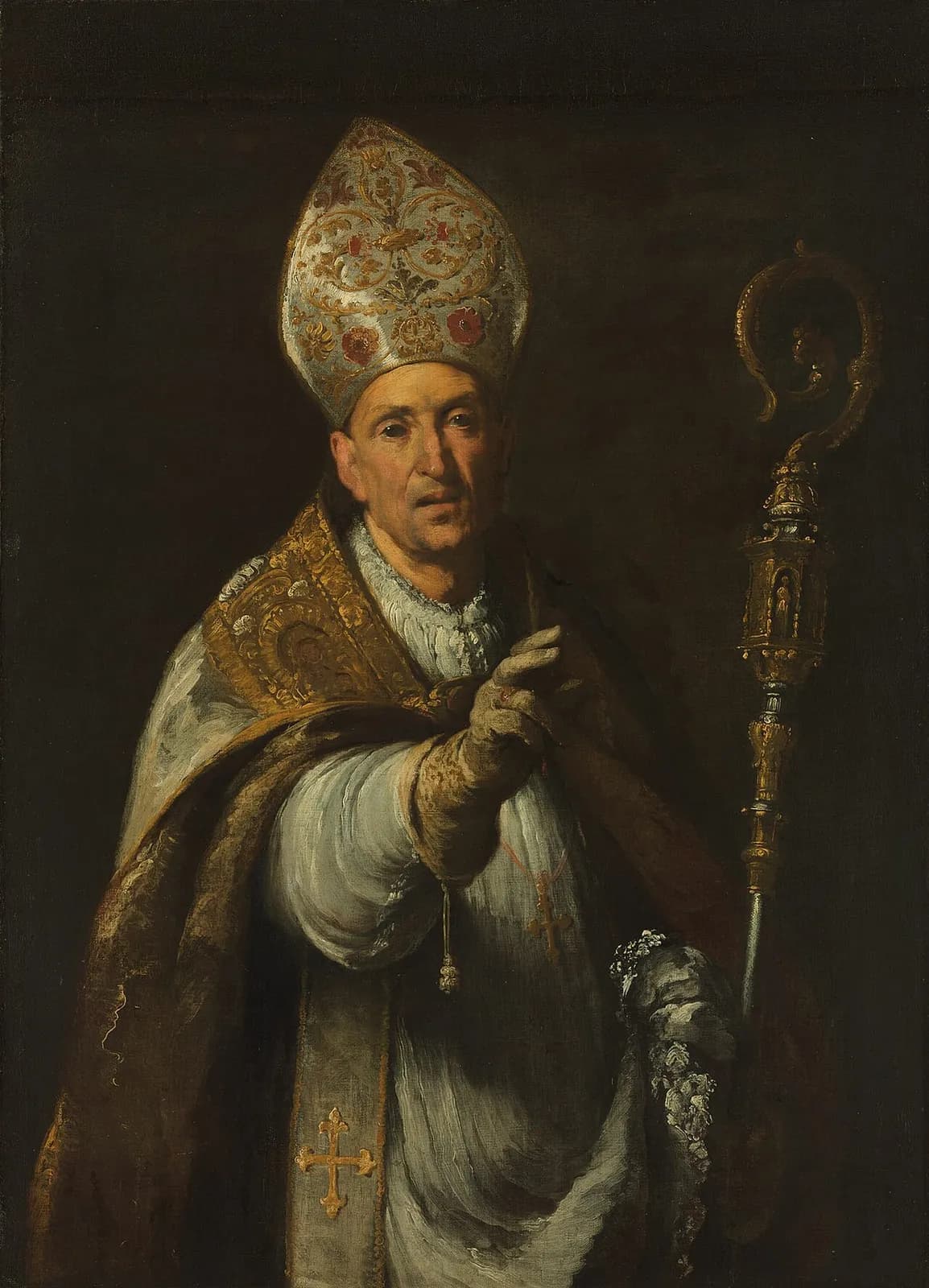 Baroque oil painting of an elderly bishop with a lined face, wearing a tall embroidered white-and-gold miter and a gold cope over white vestments, a gloved hand raised in blessing and a gilded crozier in the other, against a dark background