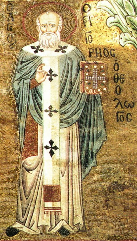 A gold-ground mosaic of a white-bearded bishop in a blue cloak and a white stole marked with black crosses, raising one hand in blessing and holding a jeweled book, with his name in Greek letters beside him