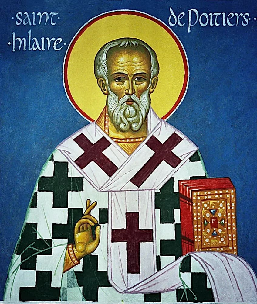 Un icono rotulado San Hilario de Poitiers, que muestra al obispo de barba blanca sobre un fondo azul intenso, con vestiduras de cruces, una mano alzada en bendición y en la otra un evangeliario con joyas
