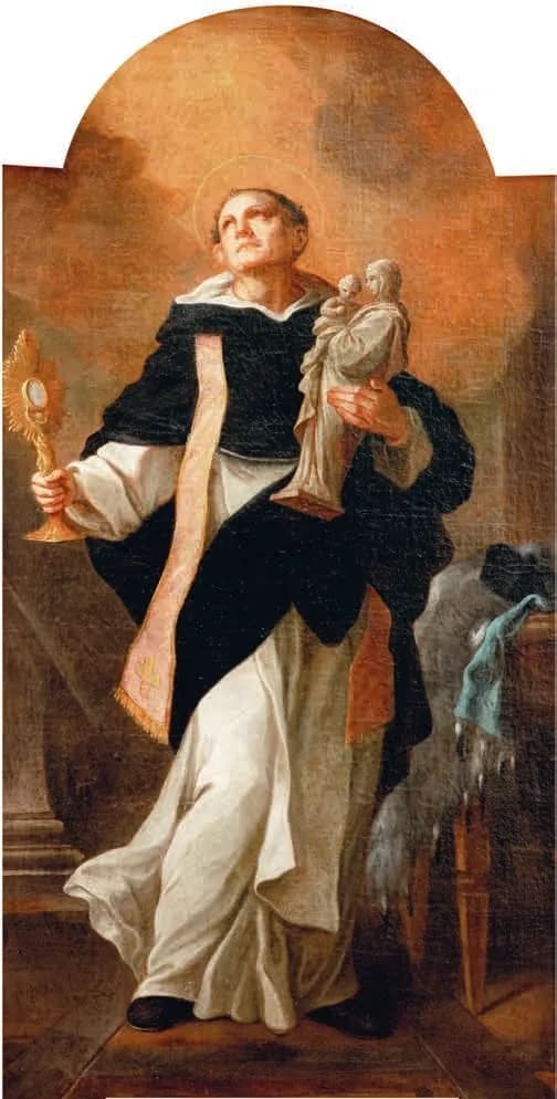 A Dominican friar in a white habit and black cloak looks upward, holding a golden monstrance in his right hand and a small statue of the Virgin and Child in his left