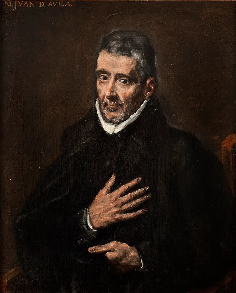 Oil portrait of a gray-haired, bearded priest in a black cassock and cloak with a white collar, his right hand laid on his chest, inscribed M. JUAN D. AVILA at the top