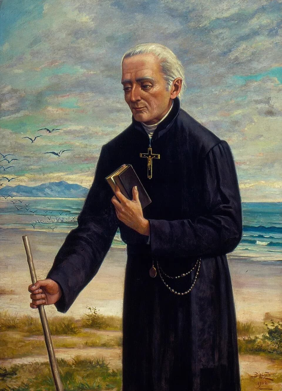Painting of a white-haired Jesuit in a black cassock standing on a beach with a crucifix on his chest and a rosary at his belt, holding a book against his breast and a walking staff, with seabirds and distant hills behind him