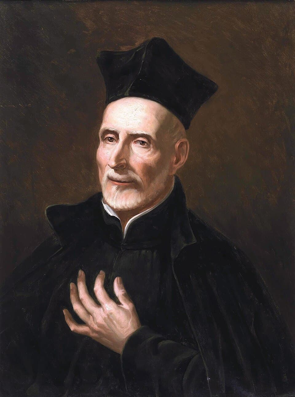 A painting of Joseph Calasanz as an elderly priest in a black cassock and biretta, hands clasped, his face lined and turned slightly downward