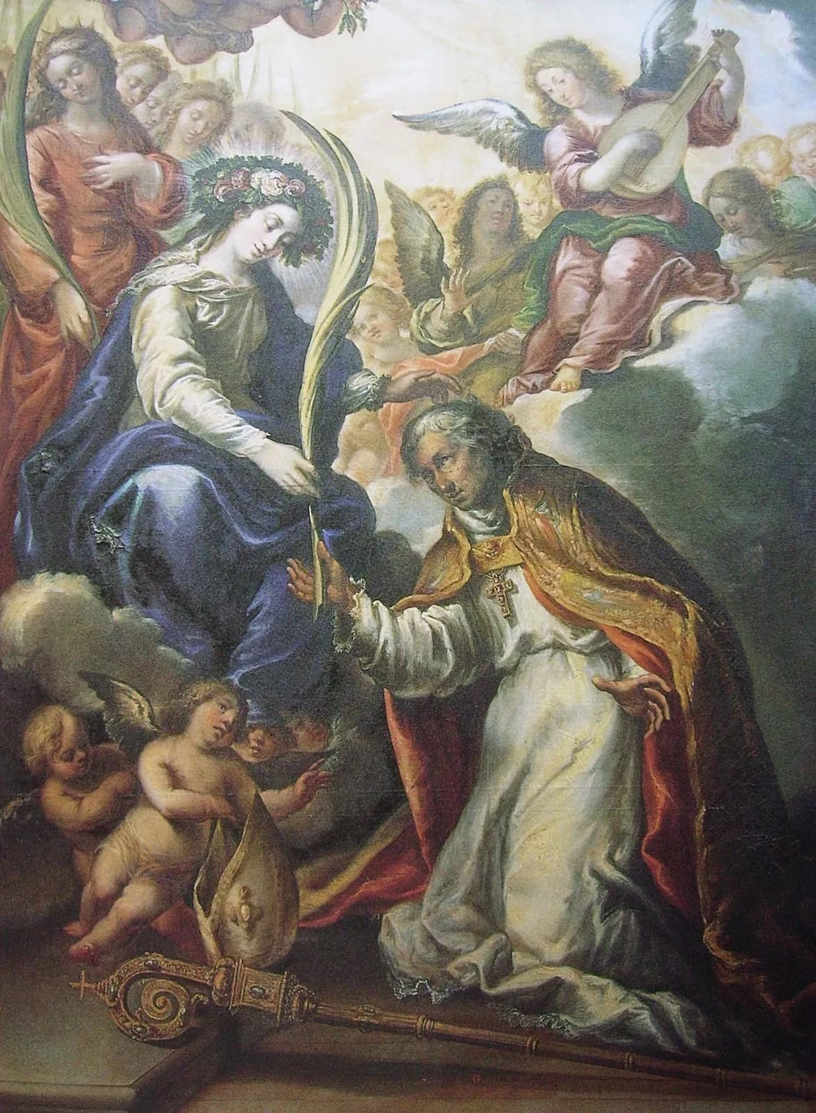 Seventeenth-century Spanish painting of a kneeling bishop in a white alb and gold cope reaching toward the Virgin Mary, crowned with roses and seated on clouds, who hands him a palm branch, surrounded by angels playing music, with his miter and crozier on the ground beside him