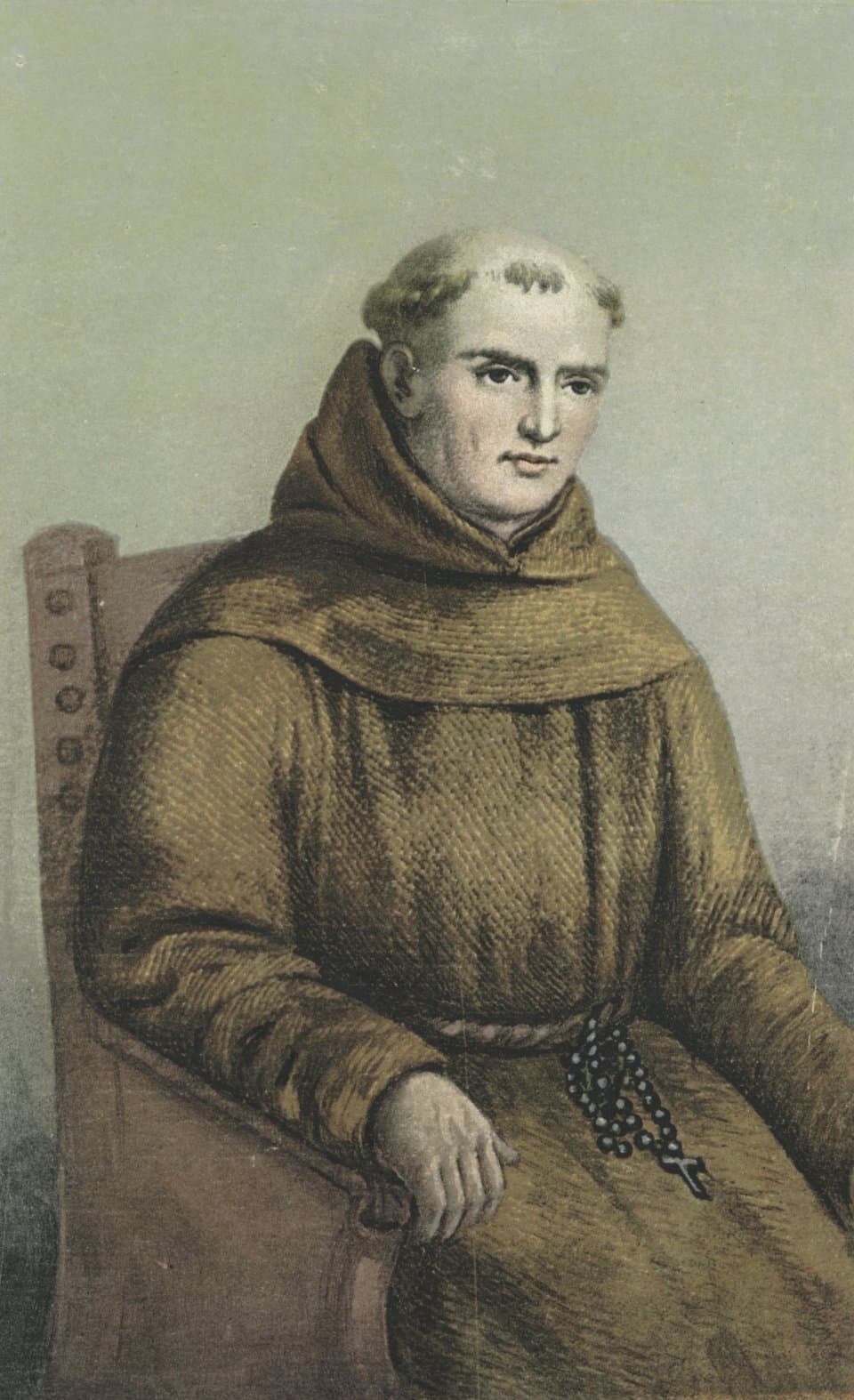 Junípero Serra seated in a wooden chair, wearing a brown Franciscan habit with a hood and a cord, a rosary hanging at his side