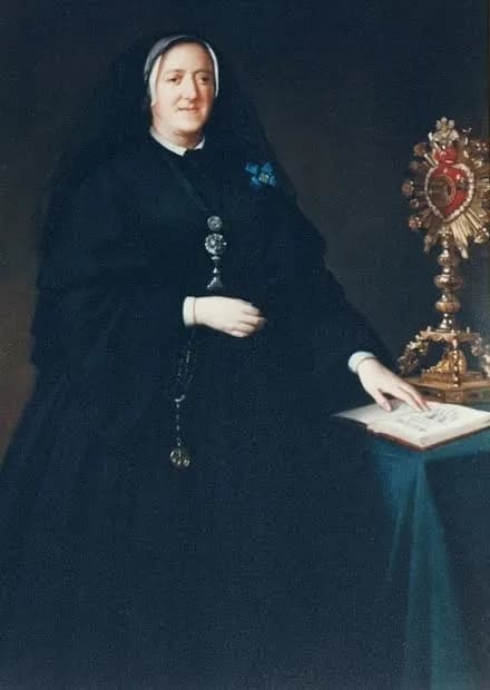Nineteenth-century oil portrait of an older woman seated in black religious dress and a black veil over a white cap, a cross and medals hanging on a chain and a small blue badge at her breast, her right hand resting on an open book on a green-covered table beside a gold monstrance with a red heart at its center