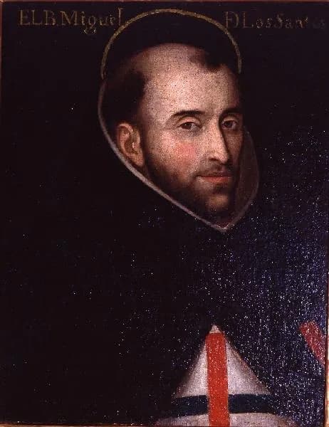Old portrait of a tonsured friar with a short dark beard and a thin halo, his head turned slightly toward the viewer, wearing a dark mantle over a white scapular marked with a red and blue cross, with the words El B. Miguel de los Santos lettered across the top