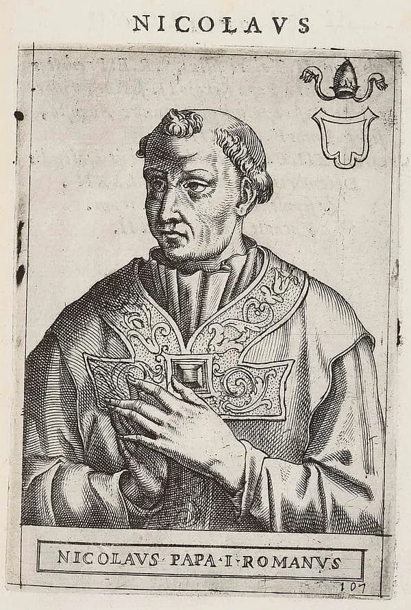 Sixteenth-century engraving of a tonsured, clean-shaven pope in a cope with an ornate clasp, shown half-length with one hand on his chest, a tiara and blank shield in the corner, under the heading Nicolaus and above the caption Nicolaus Papa I Romanus