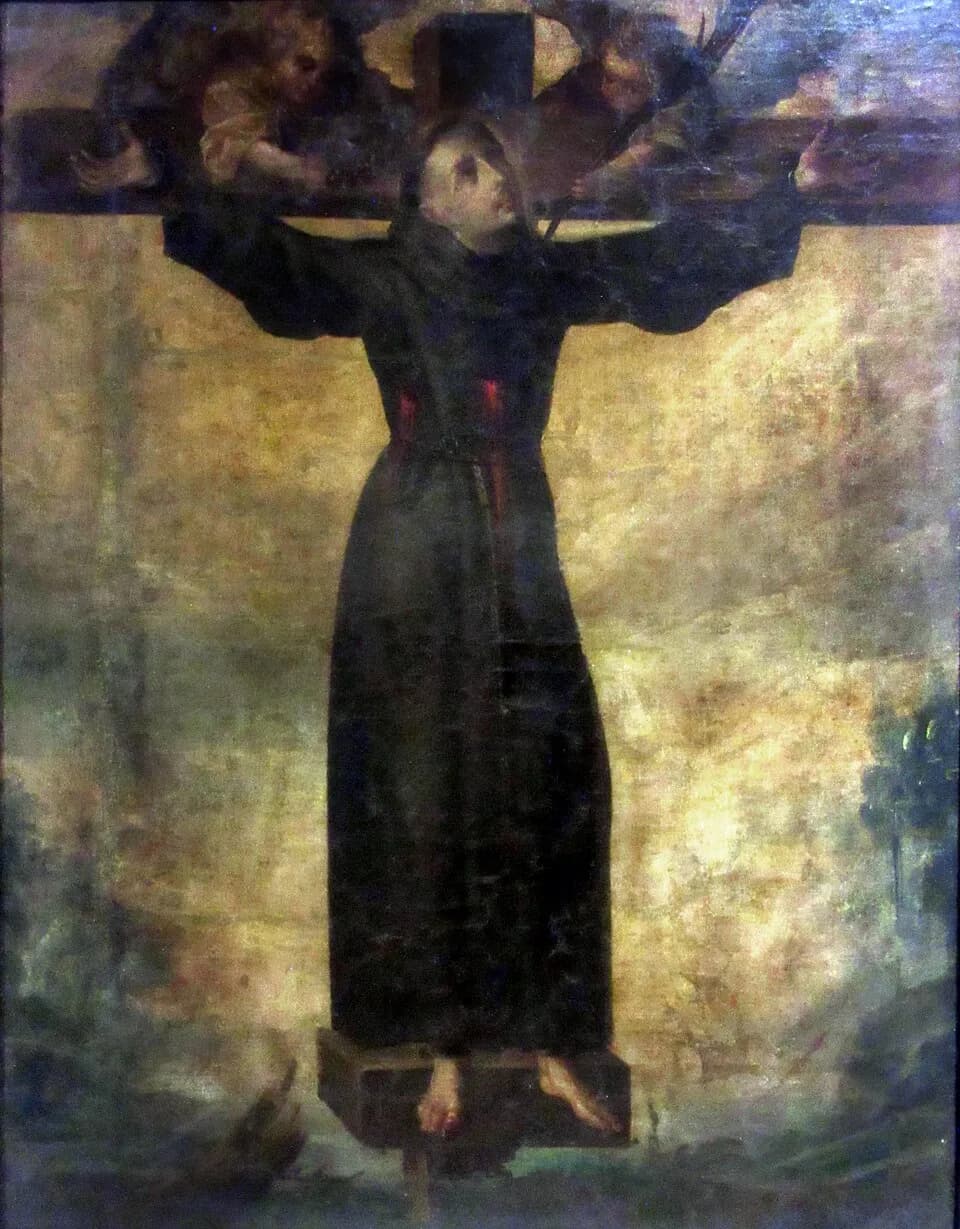 Old oil painting of a young friar in a dark habit and cord fastened to a tall cross with his arms outstretched, two red lance wounds on his chest, his face turned upward to two small angels who lean over the crossbeam, one holding a palm branch
