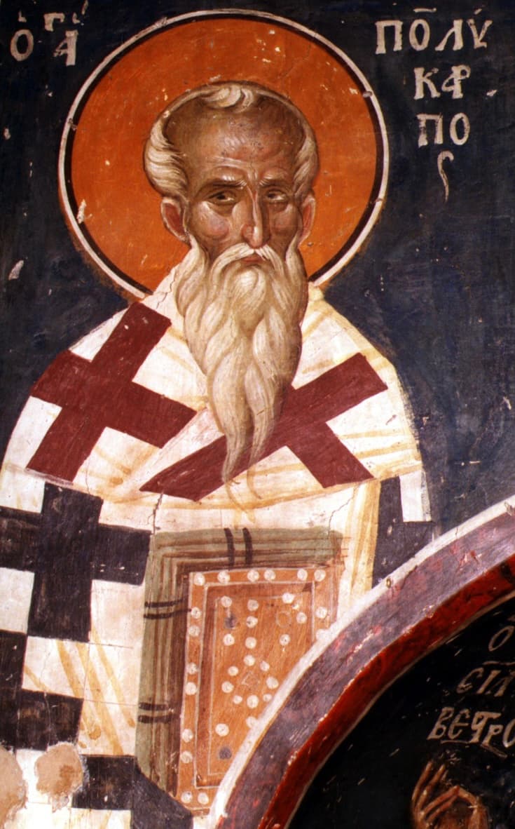 An icon of Polycarp of Smyrna as an elderly bishop with a long white beard, in a cross-patterned omophorion, holding a jewelled book of the Gospels