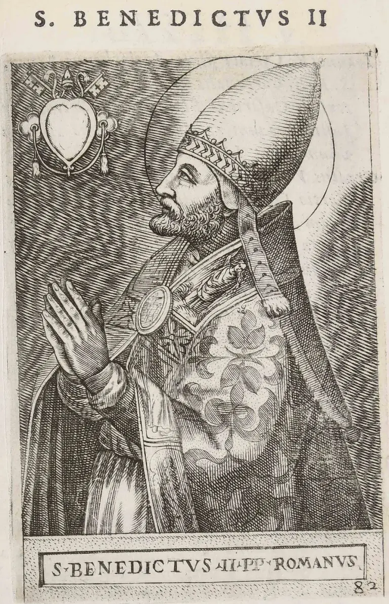 Sixteenth-century engraving of a bearded pope with a halo, in profile facing left with his hands raised and joined in prayer, wearing a tall pointed cap with a single crown and a patterned cope with an oval clasp, a blank heart-shaped shield under crossed keys at upper left, under the heading S. Benedictus II and above the caption S. Benedictus II PP. Romanus