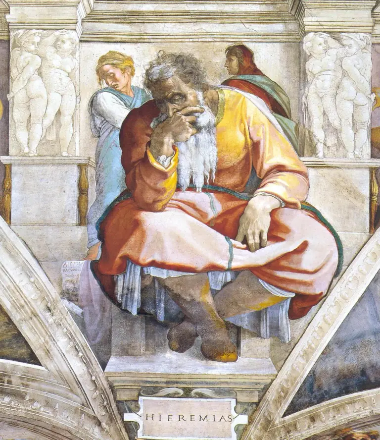 Fresco of an old white-bearded man seated on a stone bench with his legs crossed, bent forward with his chin and mouth resting in his right hand, wearing a pink and orange robe over a yellow tunic, two attendant figures behind him, carved stone pillars with painted cherubs on either side, and a plaque below inscribed HIEREMIAS