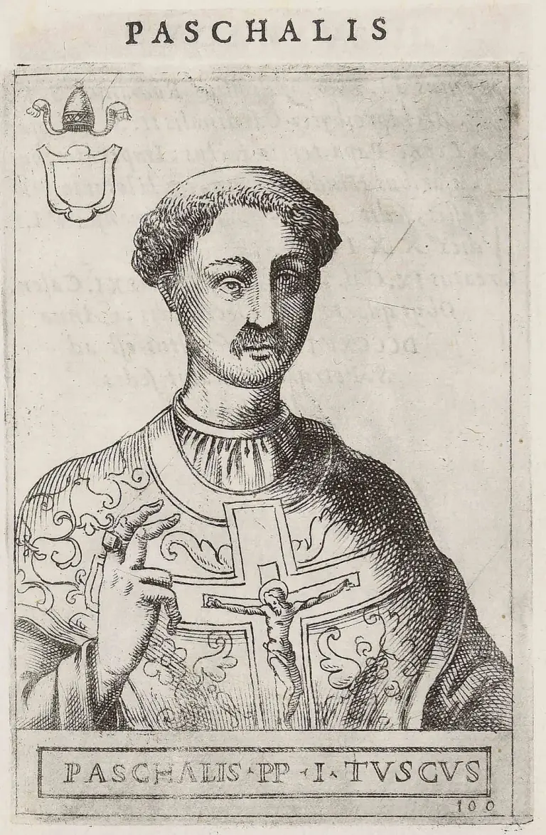 Sixteenth-century engraving of a tonsured pope with a short mustache and beard, half-length and facing the viewer, raising his right hand in blessing, a crucifix on the cross of his embroidered chasuble, a blank shield under a tiara at upper left, under the heading Paschalis and above the caption Paschalis PP I Tuscus